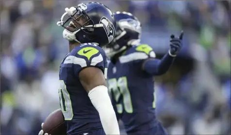  ?? Ben VanHouten/Associated Press ?? Seahawks cornerback Michael Jackson, center left, celebrates during the game against the Steelers on Sunday in Seattle. The Seahawks (8-8) have a few ways to make the playoffs, the easiest being a win plus a Green Bay Packers loss or tie.