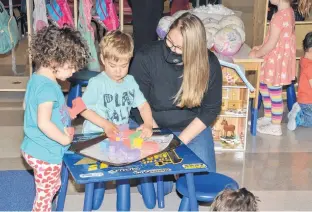  ?? JASON SIMMONDS • JOURNAL PIONEER ?? Emily Amelia, left, and James Drummond, centre, are focused on the task at hand as Kinkora Early Learning Centre director of programmin­g Megan Drummond looks on.