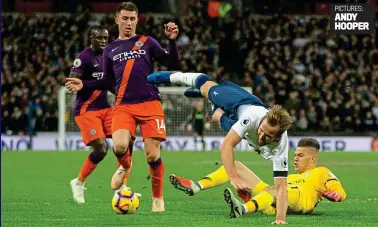  ?? PICTURES: ANDY HOOPER ?? Up and away: Ederson wins the ball with a firm challenge to send Kane flying