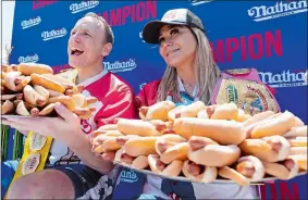  ?? JULIA NIKHINSON/AP PHOTO ?? Joey Chestnut and Miki Sudo pose with 63 and 40 hot dogs, respective­ly, after winning the Nathan’s Famous Fourth of July hot dog-eating contest in Coney Island on Monday in New York.