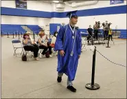  ?? BEN HASTY — MEDIANEWS GROUP ?? Ben Leister, 18, of Oley, walks to the stage to get his diploma at Oley Valley High School where the district was holding graduation ceremonies for the 2020 seniors one at a time Wednesday.