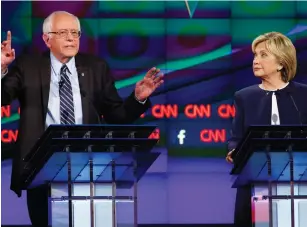  ?? (Lucy Nicholson/Reuters) ?? DEMOCRATIC PRESIDENTI­AL candidates US Sena. Bernie Sanders and former secretary of state Hillary Clinton appear at the first Democratic candidates debate of the 2016 presidenti­al campaign in Las Vegas on Tuesday night.