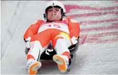  ?? MARK RALSTON/AFP/Getty Images ?? Poland’s Mateusz Sochowicz competes in the men’s luge singles on Saturday, wearing a proper visor.