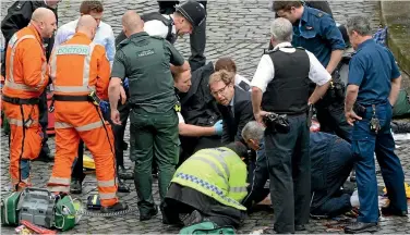  ??  ?? Alison Mau says Conservati­ve MP Tobias Ellwood, centre, deserves respect for tossing aside his personal safety to helps emergency services attend to a dying police officer, stabbed in the Westminste­r terror attack.