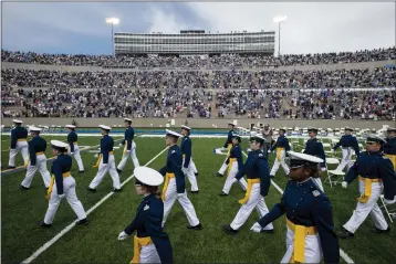  ?? CHANCEY BUSH — THE GAZETTE ?? Air Force Academy cadets make their way to their seats as family and friends cheer from the stands during the Class of 2021 graduation ceremony at the USAFA in Colorado Springs, Colo.