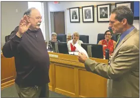  ?? NWA Democrat-Gazette/TOM SISSOM ?? Mike Jeffcoat is sworn in Thursday as a Benton County justice of the peace by Circuit Judge Brad Karren in Bentonvill­e.