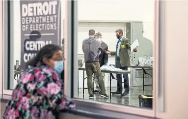  ?? BRITTANY GREESON THE NEW YORK TIMES ?? A woman looks on as election officials count absentee ballots in Detroit this month. Even before he was elected in 2016, U.S. President Donald Trump was building a conspiracy theory about voter fraud that took on new energy this year.