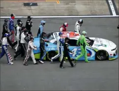  ?? Brian Lawdermilk/Getty Images ?? NASCAR drivers push the No. 43 Chevrolet, driven by Bubba Wallace, to the front of the grid as a sign of solidarity with the driver before the NASCAR Cup Series GEICO 500 Monday at Talladega Superspeed­way in Talladega, Ala.