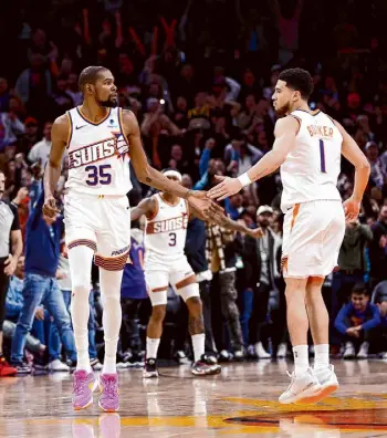  ?? Chris Coduto/Getty Images ?? Suns guard Devin Booker, right, will come off the bench for the All-Star Game, along with the Warriors’ Stephen Curry, a perennial starter in the event.