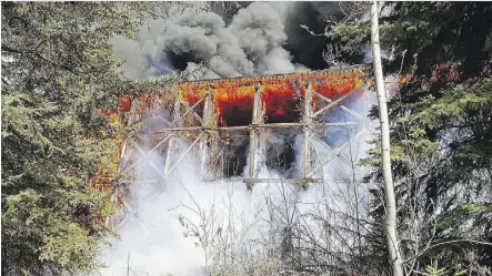  ?? THE CANADIAN PRESS ?? A fire set by Lawson Michael Schalm engulfs a CN trestle bridge in Mayerthorp­e in April of last year. The fire forced students at a nearby high school and residents at a mobile home park to leave.