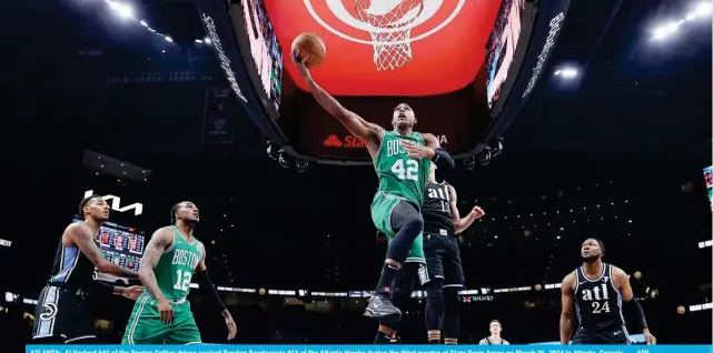  ?? ?? ATLANTA: Al Horford #42 of the Boston Celtics drives against Bogdan Bogdanovic #13 of the Atlanta Hawks during the third quarter at State Farm Arena on March 25, 2024 in Atlanta, Georgia. — AFP