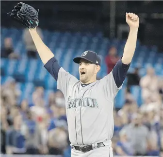  ?? FRED THORNHILL, THE CANADIAN PRESS ?? Mariners starter James Paxton, who hails from Ladner, celebrates after throwing a no-hitter against the Blue Jays in Toronto on Tuesday.