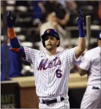  ?? JASON DECROW — THE ASSOCIATED PRESS ?? The Mets’ Jeff McNeil celebrates as he returns to the dugout after hitting a home run during the seventh inning of a game against the Phillies Sunday in New York.