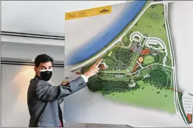  ?? CORNELIUS FROLIK PHOTOS / STAFF ?? Brady Kress, president and CEO of Dayton History, points out the rail line on a map of the 65-acre Carillon Historical Park.