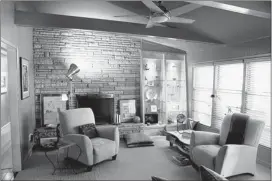  ?? PHOTOS BY KYLE KURLICK / SPECIAL TO THE COMMERCIAL APPEAL ?? Designer John Griffin’s remodel features exposed beams and stone fireplace in the living room.