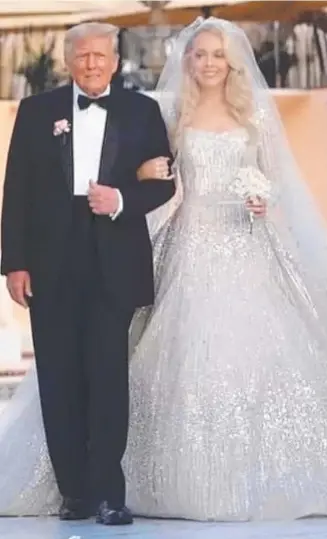 ?? ?? Donald Trump walks with youngest daughter Tiffany at Mar-a-Lago on her wedding day.