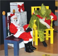  ??  ?? Eight-year-old Owen Butterwort­h, dressed as Santa, visits with the Grinch at the Swift Current Museum's Festival of Minis, Dec. 1.