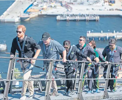  ?? Picture: Associated Press. ?? Harry climbed the Sydney Harbour Bridge with some representa­tives from the Invictus Games.