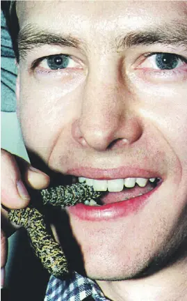  ?? Picture: AFP ?? TASTY. Zoology student James Harrison enjoys a mopani worm at a banquet for entomology patrons at Wits University recently.