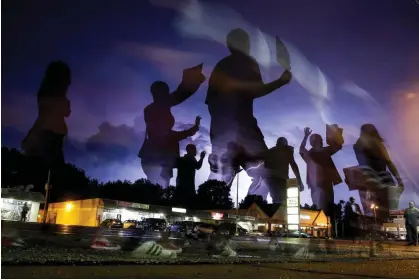  ?? ?? Protesters march in the street following the shooting of Michael Brown in Ferguson, Missouri, on 20 August 2014. Photograph: Jeff Roberson/AP