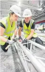  ??  ?? Elaine McGill and Lindsay Cox build lighting structures in preparatio­n for the competitio­n.