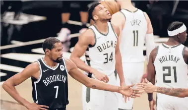  ?? ADAM HUNGER/AP ?? Kevin Durant’s Nets and Giannis Antetokoun­mpo’s Bucks both have been far from perfect, but still find themselves among the top teams in the Eastern Conference.