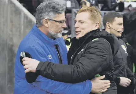  ??  ?? Neil Lennon, right, and Craig Levein embrace at Tynecastle before January’s Scottish Cup derby.