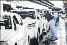  ??  ?? This file picture taken on Aug 8, 2014 shows employees of Toyota Motor’s subsidiary Toyota Motor Kyushu checking Lexus vehicles on an assembly line at the Miyata Plant in Miyawaka, Fukuoka Prefecture. Confidence among some of Japan’s biggest firms has...
