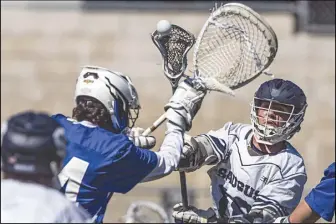  ?? Chris Torres/The Signal ?? (Top) Saugus’ Tommy Forrand (18) passes the ball to Connor Levine (10) during a CIF Division 2 boys lacrosse playoff match between the Saugus Centurions and the Cate Rams at the Saugus High School football field in Saugus last week.