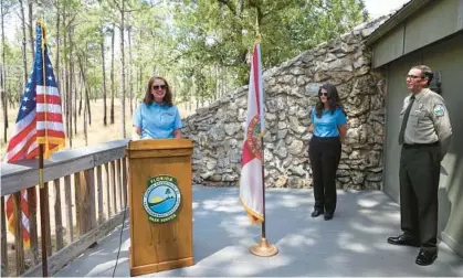  ?? RICARDO RAMIREZ BUXEDA/ORLANDO SENTINEL ?? Florida State Parks Foundation Board President Tammy Gustafson speaks Wednesday as Duke Energy Vice President Sharon Arroyo, middle, and Florida Department of Environmen­tal Protection Bureau Chief Robert Yero, right, listen.