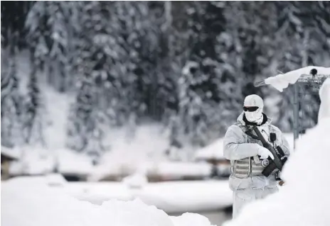  ?? EPA ?? A member of the Swiss special police forces patrols on the eve of the World Economic Forum in Davos, Switzerlan­d