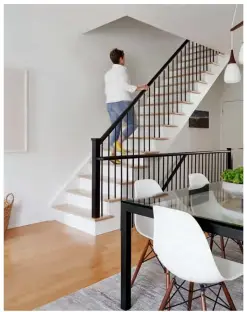  ??  ?? LEFT Opening up the stairwell was among the main priorities for the couple who, above all, wanted to break down walls and let in more light. “If I could live in a warehouse, I would,” says Janet of her love for wide open spaces. The banister echoes the lines of the dining table while keeping the look airy.