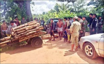  ?? SUPPLIED ?? Officials inspect a haul of illegal rosewood in Preah Vihear province’s Choam Ksan district on Wednesday.