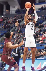  ?? Jessica Hill / Associated Press ?? UConn’s Tyler Polley, right, shoots over Md.-Eastern Shore’s Donchevell Nugent on Tuesday.