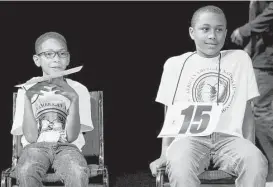  ??  ?? Joshua Walker pulled off a double win with his brother Joseph, right, taking home first and second place, respective­ly, at the spelling bee, which was held at Houston Community College’s Heinen Theater.
