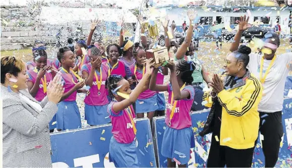  ?? ?? St Patrick’s Primary celebrate after winning the INSPORTS Allisland Primary Schools Netball title at the Discovery Bay Community Centre in St Ann recently. Here they celebrate with Minister of Sports Olivia Grange (2nd right) and Member of Parliament for St Ann North Western Krystal Lee (left).