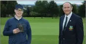  ??  ?? Padraic Gahan receives his third-place prize from Baltinglas­s Golf Club captain Liam Horgan.