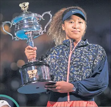  ??  ?? Naomi Osaka celebrates with the Daphne Akhurst Memorial Cup after beating Jennifer Brady (inset) in the women’s singles final at the Australian Open