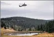  ??  ?? MORGAN TIMMS/Taos News A Blackhawk helicopter hovers to collect water from Luna Canyon resident John Abeyta’s dip site Sunday (Oct. 25).