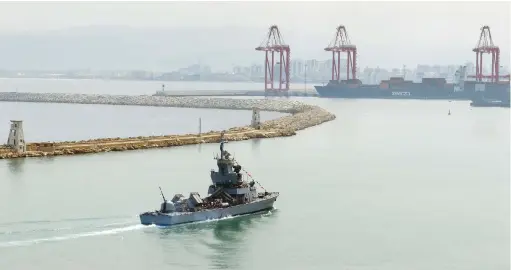  ?? (Ian Geoffrey Timberlake/AFP via Getty Images) ?? A WARSHIP with visitors aboard leaves Haifa Port in June. Already in 2018, GPS tampering blocked signals that the port’s crane operators needed, former NCD head Yigal Unna said.