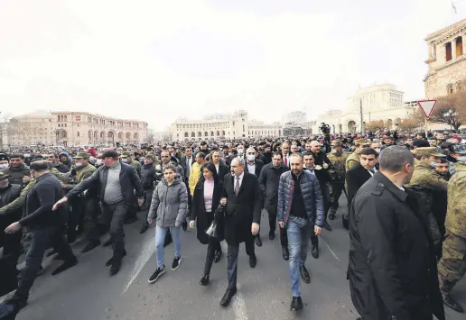  ??  ?? Armenian Prime Minister Nikol Pashinian (C) walks with his supporters to protest the coup attempt, Yerevan, Armenia, Feb. 25, 2021.