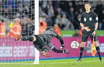  ?? ?? Match winner: Danny Ward plunges to his left to make a decisive penalty shoot-out save to send Leicester City into the quarter-finals of the Carabao Cup