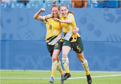  ??  ?? Australia’s Elise Kellond-Knight (left) and Karly Roestbakke­n celebrate after the Matildas’ World Cup win over Brazil.