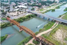  ?? Mark Mulligan / Houston Chronicle ?? A U.S. Customs and Border Protection boat heads south on the Rio Grande at the internatio­nal border crossing between Eagle Pass and Piedras Negras.