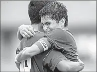  ?? NWA Democrat-Gazette/JASON IVESTER ?? Rogers senior Jessie Ramirez hugs teammate Alex Balderas during Saturday’s victory over Springdale Har-Ber in Fayettevil­le.