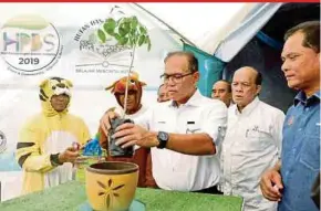  ?? PIC BY SHAHRINNAH­AR LATIB ?? Pahang Menteri Besar Datuk Seri Wan Rosdy Wan Ismail planting a tree to launch the state-level World Town Planning Day and Internatio­nal Day of Forests at Pantai Air Leleh, near Pekan, yesterday.