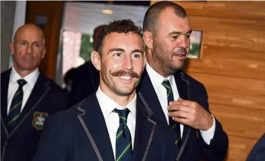  ??  ?? Target set: Australia’s scrum-half Nic White (centre) and head coach Michael Cheika (right) arriving for a team welcoming ceremony at Ebetsu, Hokkaido Prefecture, on Wednesday. Cheika said he’s not worried over reports that the Wallabies have been told to reach at least the final in the Rugby World Cup which starts in Japan today. — AFP