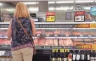  ?? SCOTT OLSON/GETTY IMAGES VIA TNS ?? A customer shops for meat at a supermarke­t in June in Chicago, Ill. Inflation rose 5% in the 12-month period ending in May, the biggest jump since August 2008.