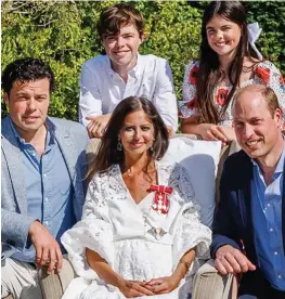  ?? ?? Royal appointmen­t: Surrounded by her proud husband and children, Deborah receives her damehood from William