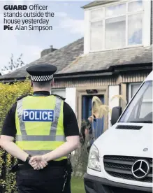  ??  ?? GUARD Officer stands outside the house yesterday Pic Alan Simpson